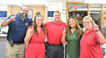 Staff holding up a finger to show we are ready to serve.