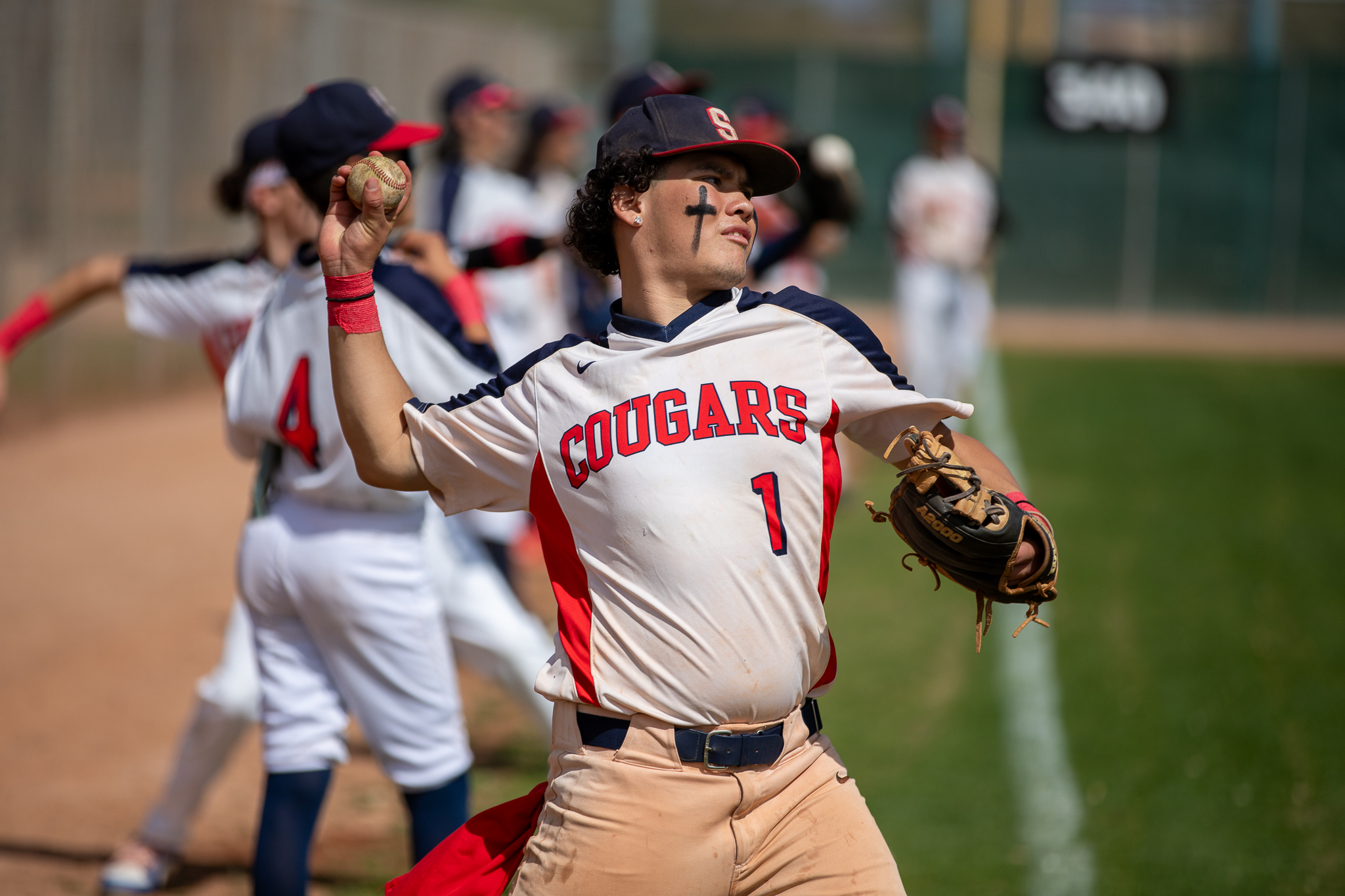 A Sahuaro player throws a ball out onto the field