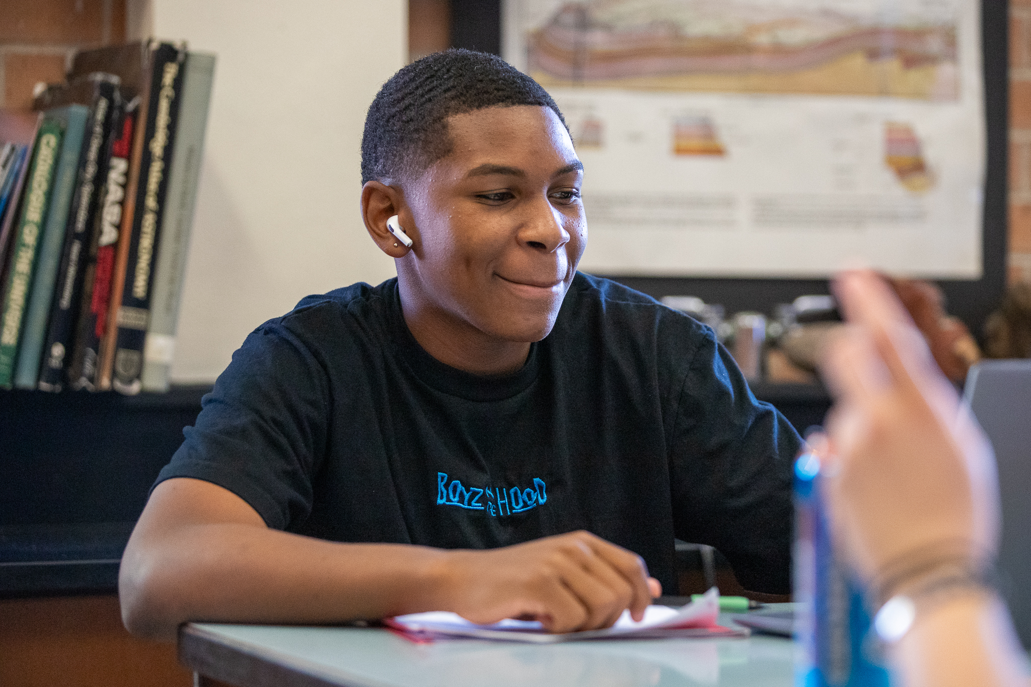 A teen boy works on his laptop