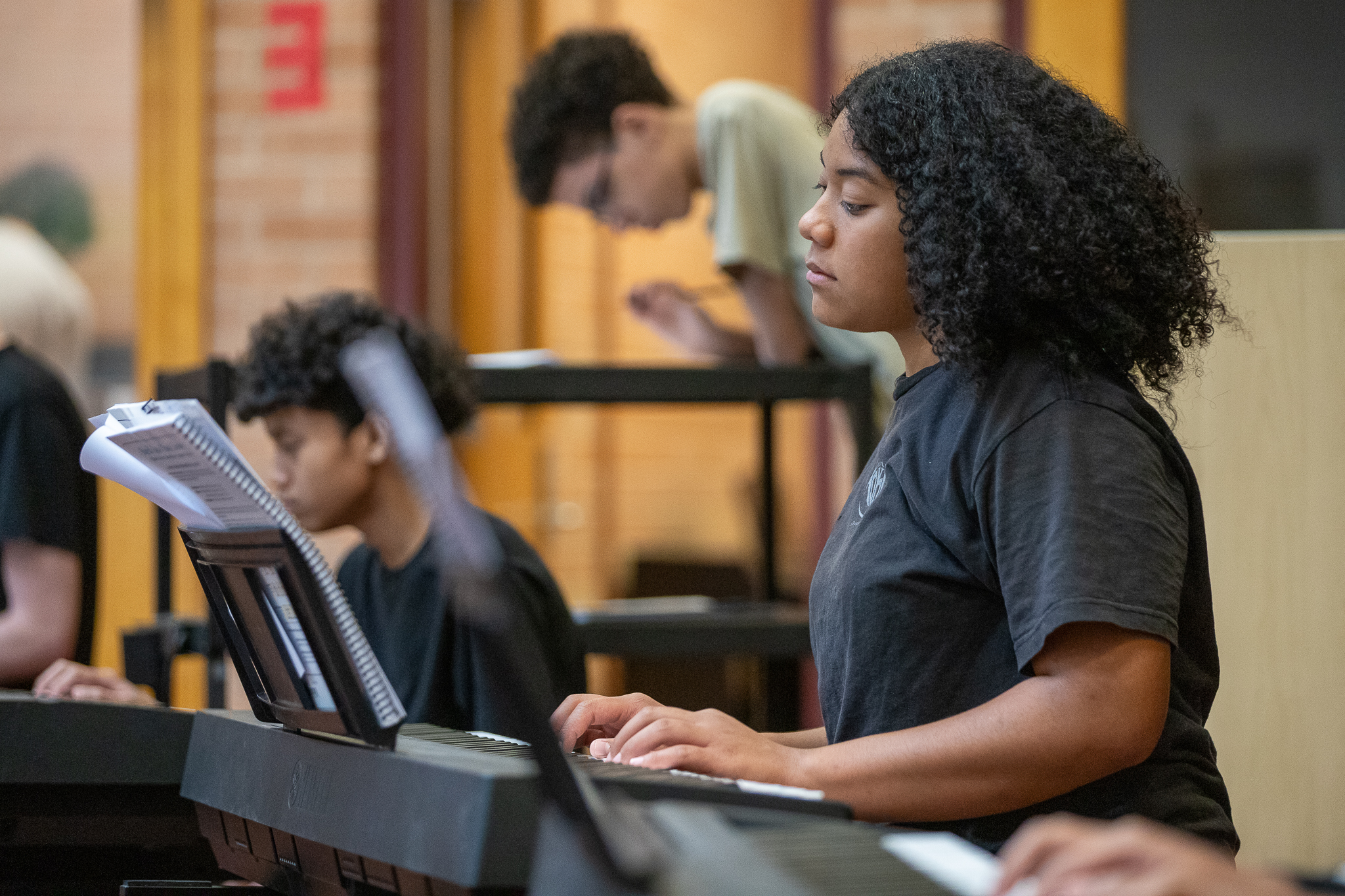 A teen girl plays keyboards