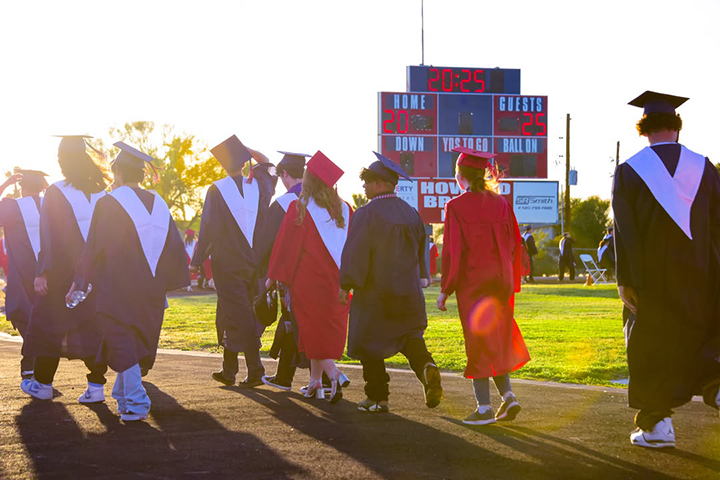 Graduates walk into the stadium