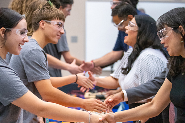 Students shake the hands of Governing Board members
