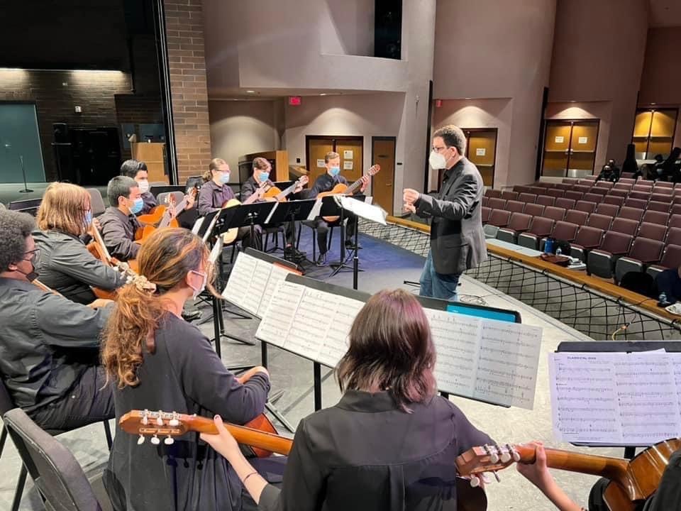 Students playing guitars